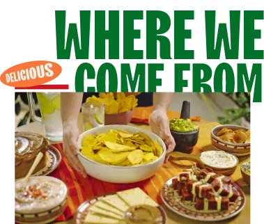 Traditional Latin food spread with plantain chips, guacamole, and assorted dishes on a colorful table