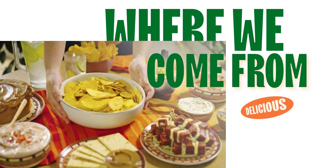 Traditional Latin food spread with plantain chips, guacamole, and assorted dishes on a colorful table