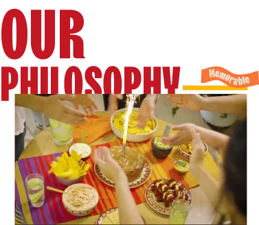 Friends gathered around a festive table sharing drinks and Latin snacks, embodying Mayte's philosophy