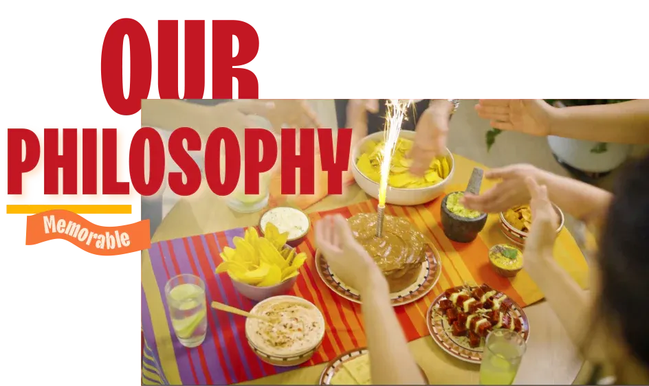 Friends gathered around a festive table sharing drinks and Latin snacks, embodying Mayte's philosophy