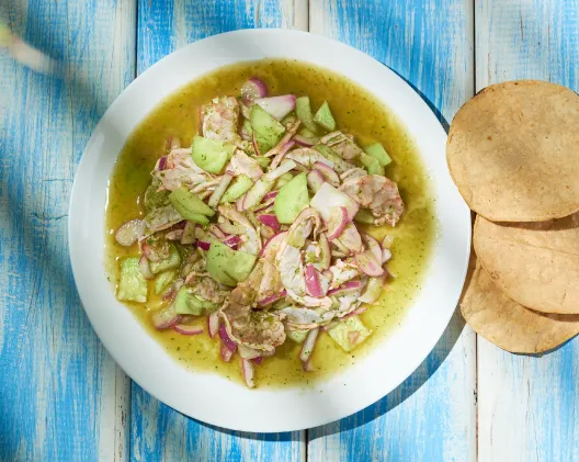 Aguachile verde with shrimp, cucumber, and red onion in green chile sauce served with tostadas