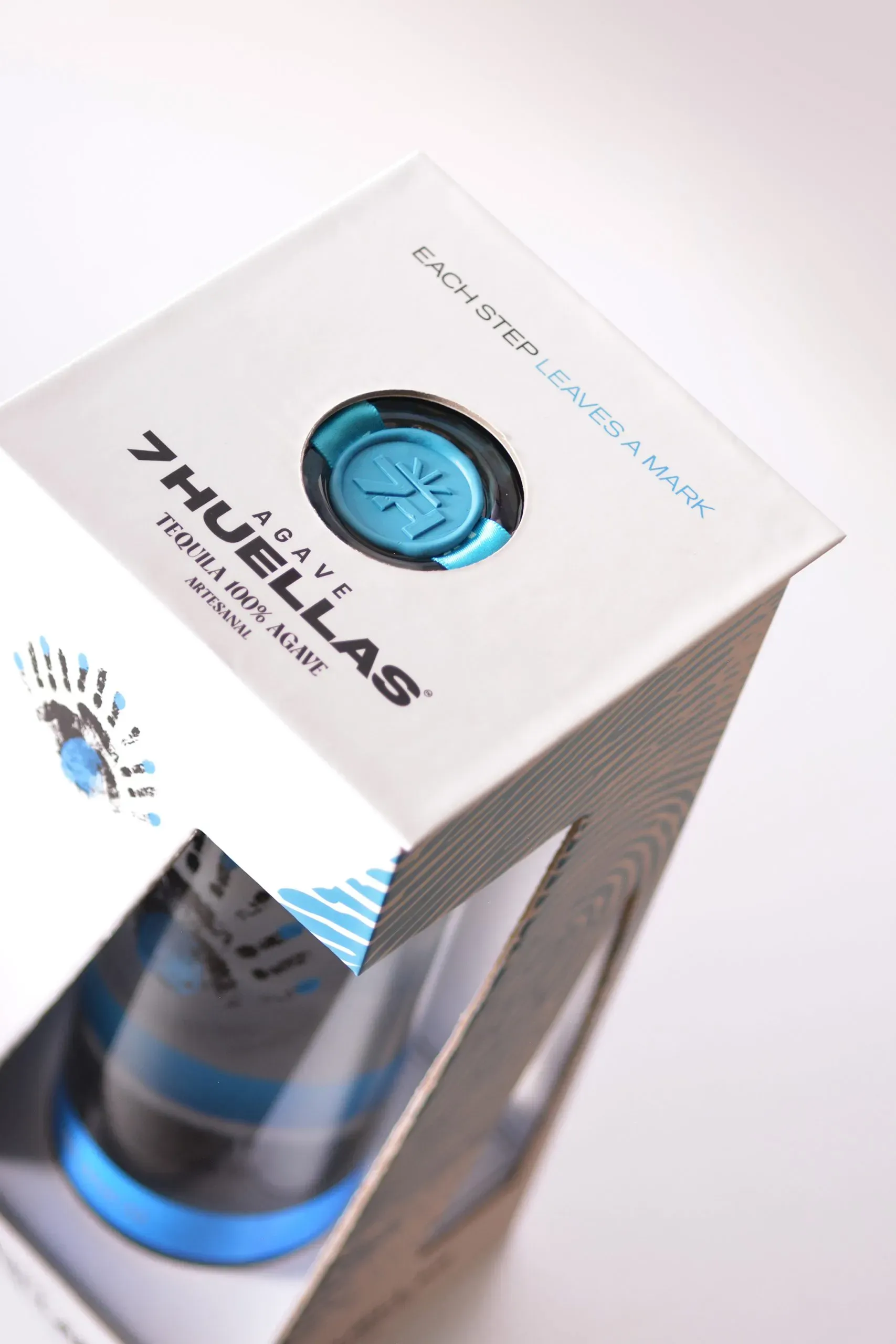 Blanco gift box top view showing wax seal and 'Each Step Leaves a Mark' text