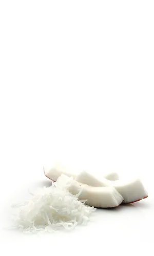Fresh coconut pieces with shredded coconut on white background