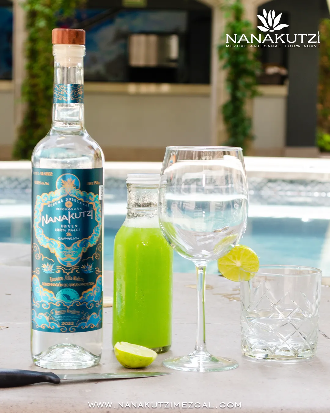 Nanakutzi Cupreata bottle with lime juice and glasses poolside