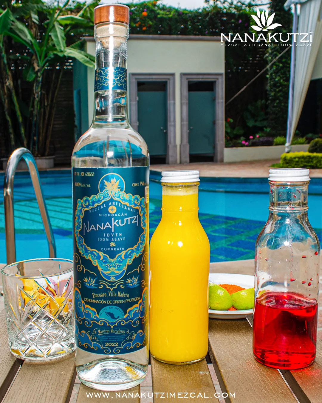Nanakutzi Cupreata bottle with juice mixers by a turquoise pool