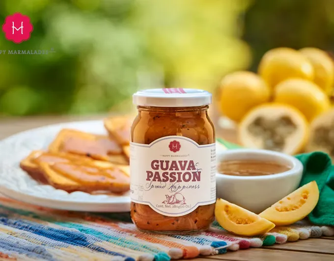 Guava Passion jar close-up with spread on toast and fresh guavas