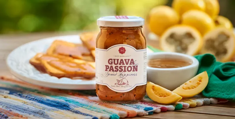 Guava Passion jar on colorful woven mat with toast, guavas, and tea