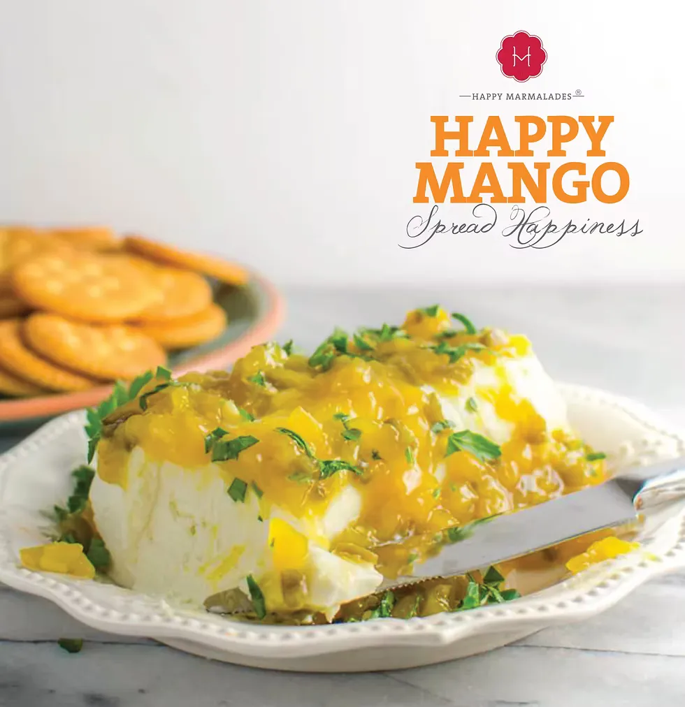 Happy Mango spread over cream cheese block garnished with herbs, served with crackers