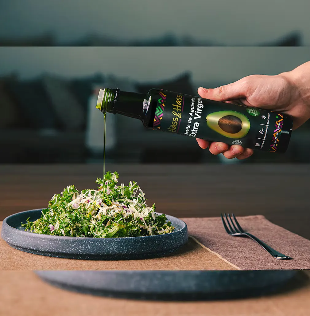 Hass & Hass avocado oil being drizzled over fresh green salad