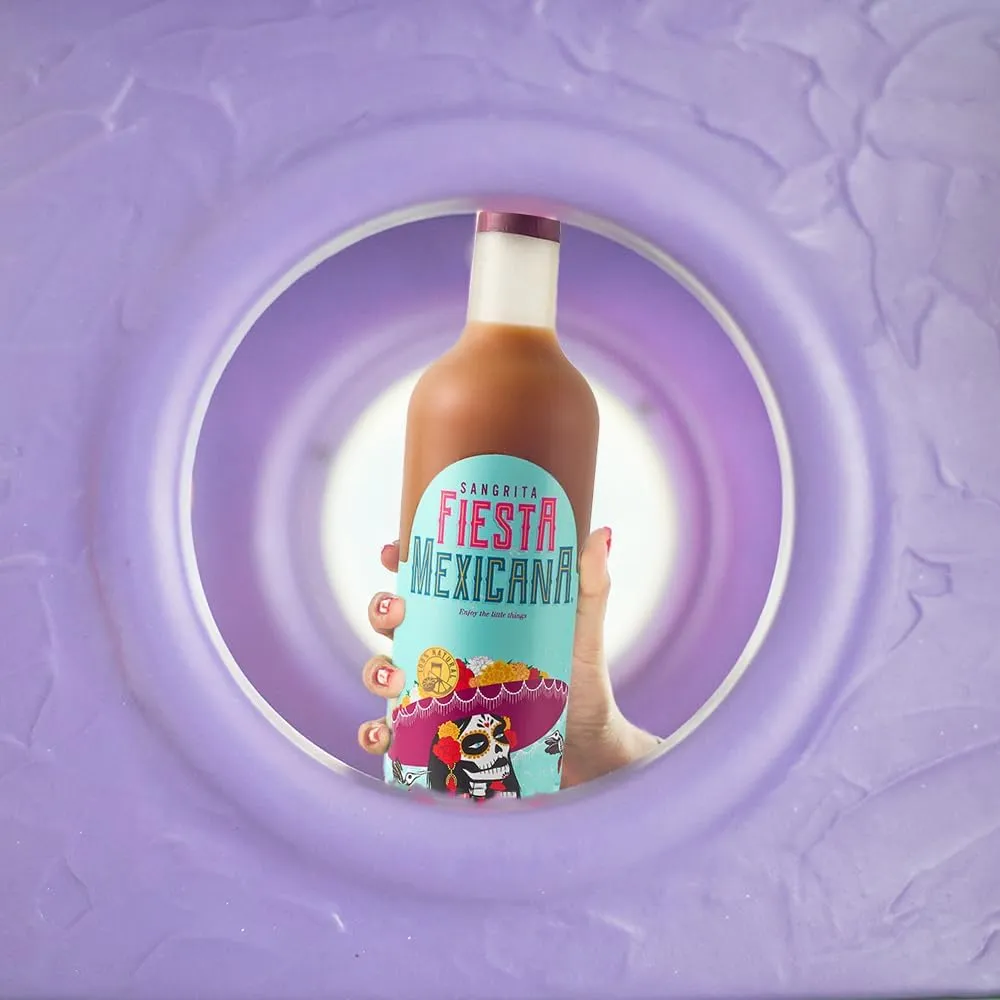 Hand holding Sangrita bottle through purple circular frame