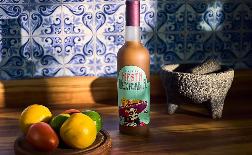 Sangrita bottle in Mexican kitchen with Talavera tiles and molcajete, wide view