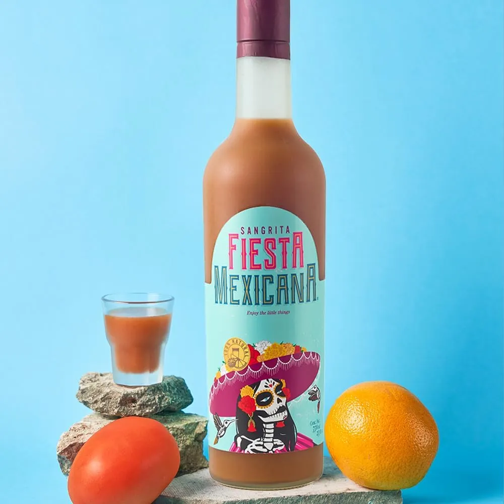 Sangrita 750ml and mini 50ml bottles with cocktail glass, citrus, and greenery